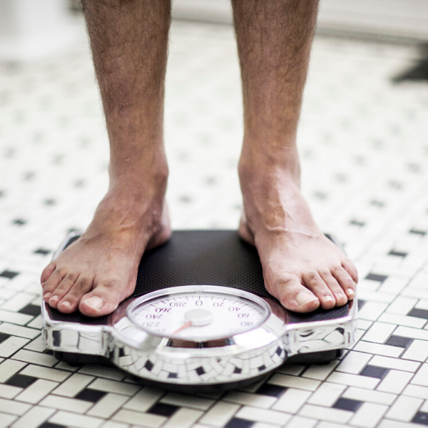 man-standing-on-weighing-scales 